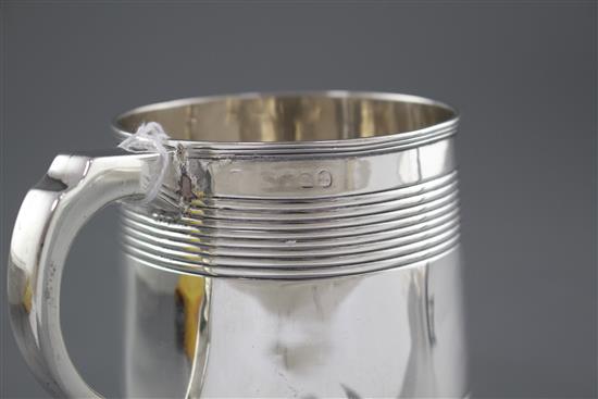A Georgian reeded silver mug, (marks rubbed and top of handle is repaired), height 96mm, 8.5oz.